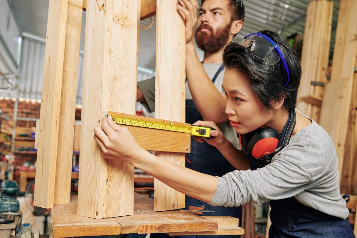 contractor measuring wood
