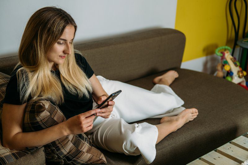 Online shopping, Black Friday sale, Holiday deals e-commerce, internet banking, spending money concept. Young woman at home holding credit card and using laptop computer and cell phone.